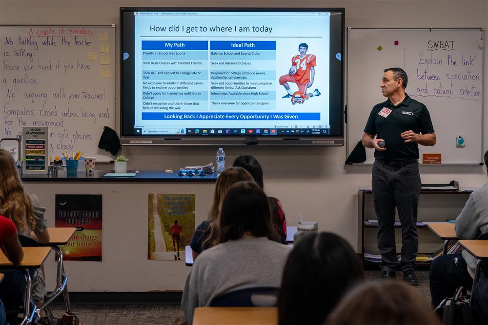 A guest speaker from Northrop Grumman talks with a class at Bogle Junior High School